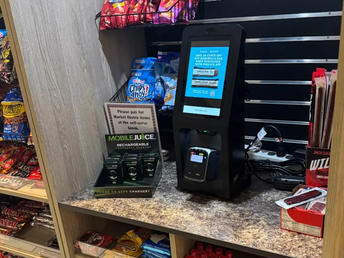 Mobile Juice counter display of emergency chargers shown at a self-serve snack area.