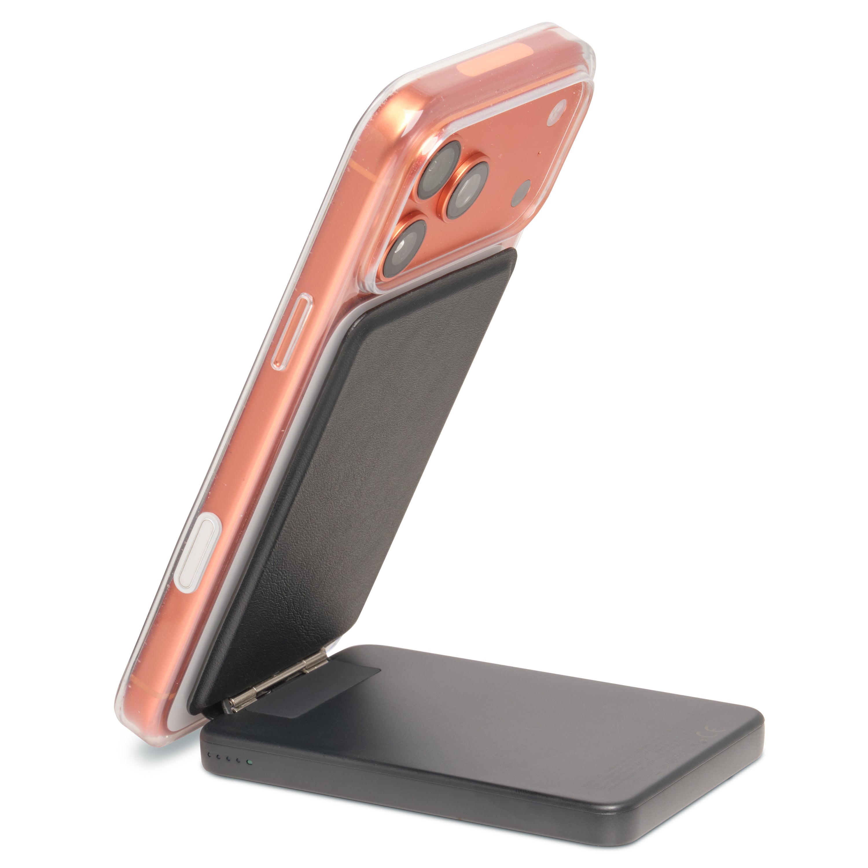 Rose gold phone on a black wireless charging stand against a white background